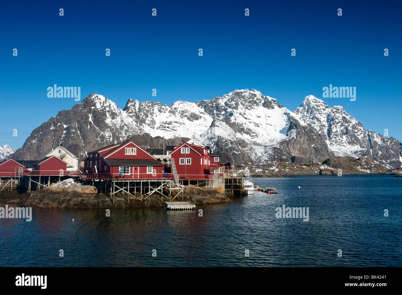 Traditional red wooden Rorbu fishermens` huts in village of Henningsvaer in Lofoten Islands in Norway Stock Photo